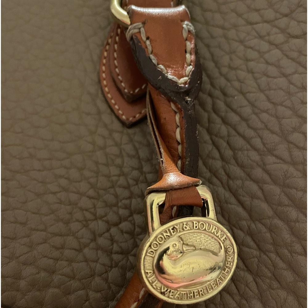 A hand bag with straps Dooney & Burke